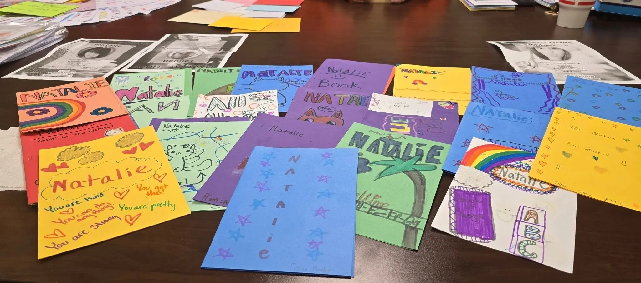 Volunteers sorting handmade cards across a long table