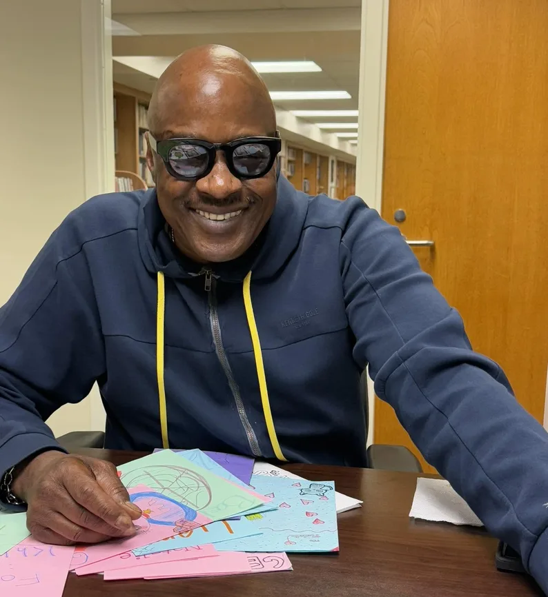 A volunteer making a card at a table
