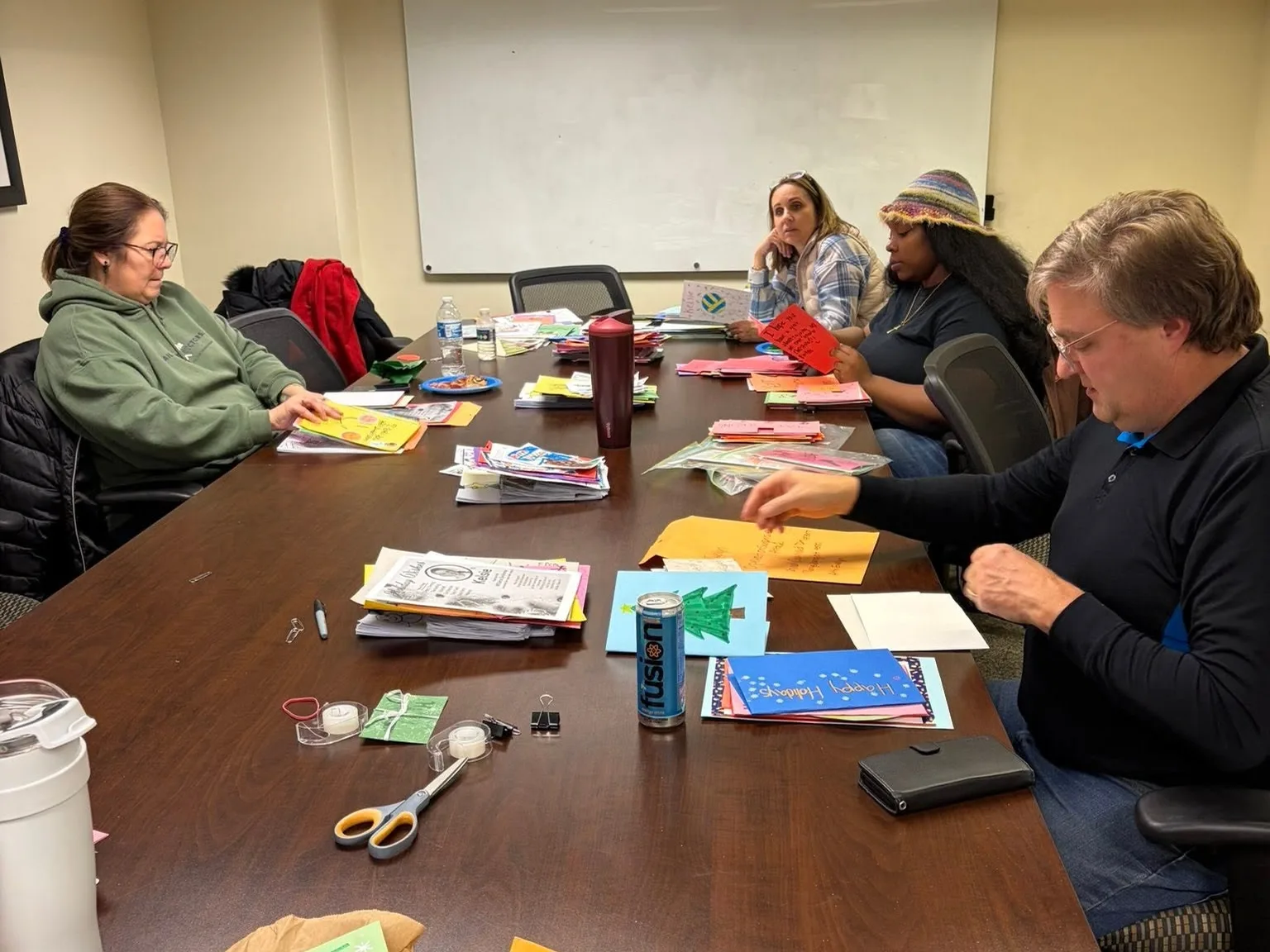 Volunteers packing cards into envelopes
